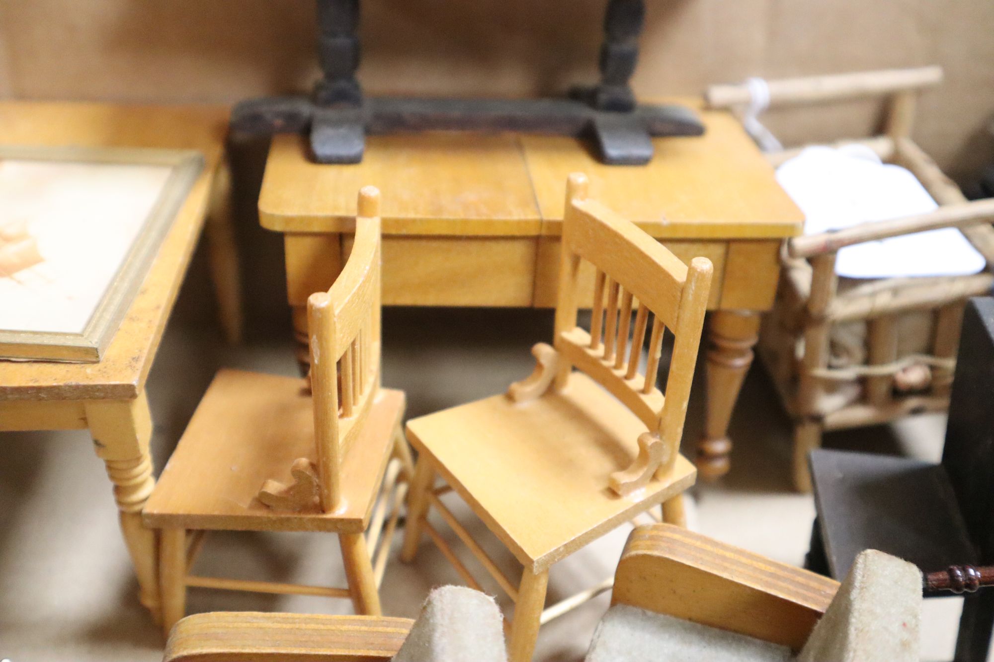 A collection of dolls and dolls house furniture displayed in room settings in a pine cupboard, width 84cm, depth 36cm, height 132cm